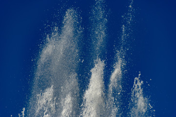 Flying water bursts on blue background