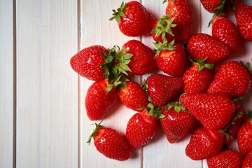 Fresh juicy red strawberries on white  table