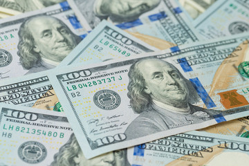 Obraz na płótnie Canvas Background of one hundred dollar bills. Benjamin Franklin on USA money banknote