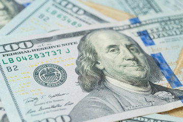 Obraz na płótnie Canvas Background of one hundred dollar bills. Benjamin Franklin on USA money banknote