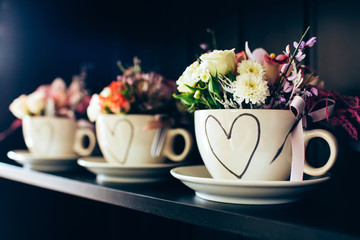 white cup with a picture of the heart. Flowers March 8th. Flowers for Valentine's Day. Mothers Day.
