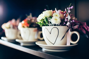 white cup with a picture of the heart. Flowers March 8th. Flowers for Valentine's Day. Mothers Day.