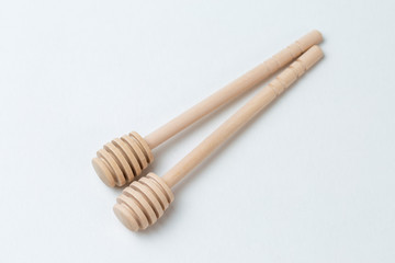 Wooden sticks for honey on a white background