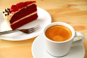 Closeup a Cup of Hot Espresso Coffee with a Slice of Red Velvet Shortcake in Background