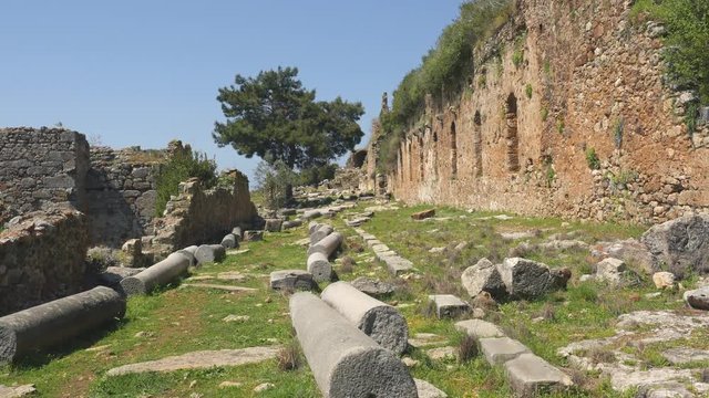 Beautiful view of ancient castle ruins with calm Mediterranean sea on background.