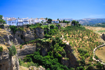 Panoramic view on ancient village Ronda located precariously close to the edge of a cliff in Andalusia, Spain