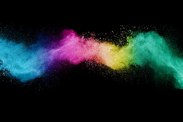 Abstract powder splatted background. Colorful powder explosion on black background. 