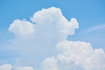 Naklejka na ściany i meble Fluffy white clouds hung in blue sky.