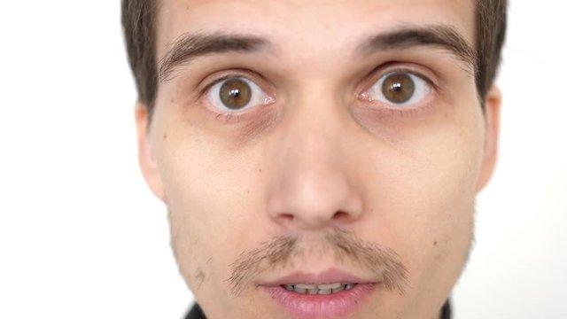 Close-up face of a young emotional man with brown eyes. 3840x2160