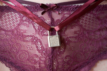 steel lock on the sexy woman's pants, virginity concept - obrazy, fototapety, plakaty