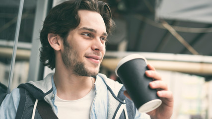 Young handsome man drinking coffee