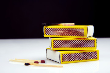 box of matches with burnt and fresh match sticks