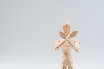 Refusal gesture, Wooden dummy, crossed hands on white background, copy space for your object or text