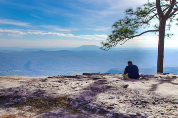 Tourists watch the landscape at the viewpoint of the tourist season on Phu Kradueng in Thailand.