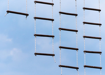 rope ladder against a blue sky and clouds © Sofiia