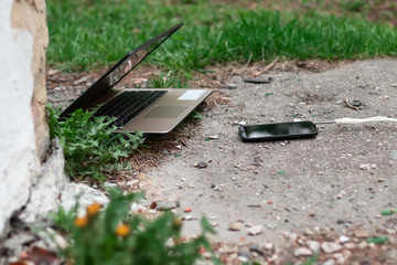 Laptop and smartphone during lunch. Powerful device absorbs outdated gadget. Abstraction.