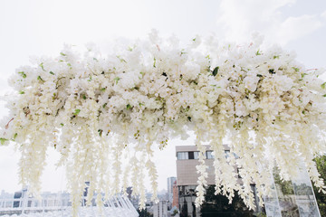 Wedding flower decorations from white roses. Decoration for the ceremony.