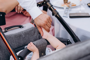 Legs of a baby in the hands of parents, Baby's feet