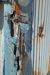 crumpled corner of corrugated steel sided industrial building 