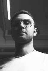 Black and white photo. Portrait of a guy wearing sunglasses.