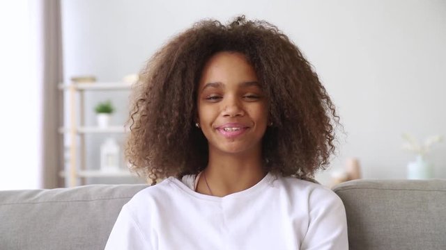 Happy african girl talking to camera make skype video call