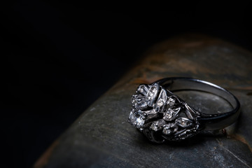 diamond ring on a Black Stone with Side Lighting.