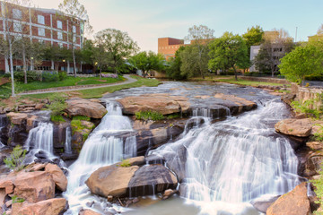 View at Greenville downtown waterfall in Falls park from the hanging Liberty bridge. Beautiful, powerful and very attractive for visitors. - 267978786