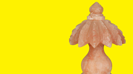 salt decoration item with yellow light in it. colorful background image. black background and lighten background. decoration item and antique item.