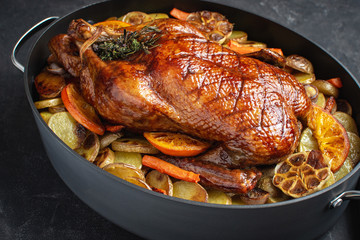 Roasted Whole Duck with Potatoes, Carrots and Oranges on Rustic Dark Stone Background - 267979386
