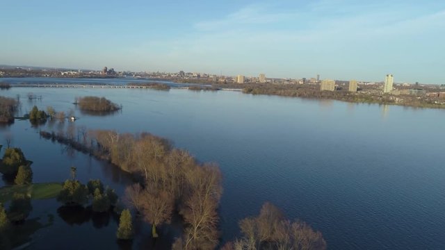 Rising drone footage over the Ottawa River during the 2019 flood facing the Champlain bridge and downtown Ottawa.