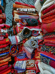 Colorful handmade rugs piled up on display at central market. Traditional handmade colorful rug