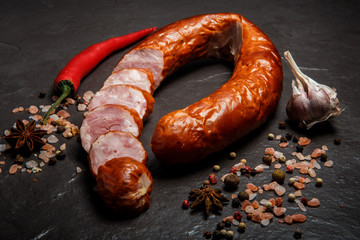 sliced circle of dry cured ham sausage with garlic and chili