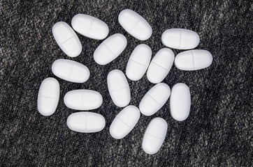 white pills on black background