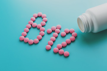 Pink pills in the shape of the letter B12 on a blue background, spilled out of a white can, low contrast