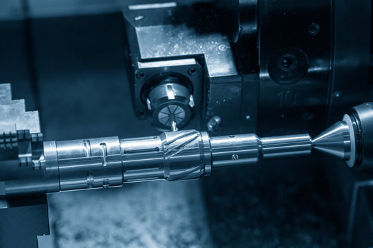 The CNC lathe machine slot cutting by the milling turret. Hi-technology automotive part manufacturing process on turning machine.