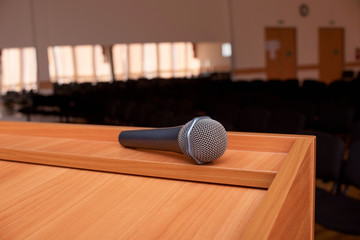 microphone on tribune in front of meeting room empty chairs