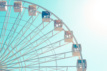 Big city ferris wheel on a background of clean blue sky