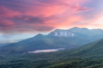 Soft, dreamy sunset view from a Caesars head overlook in South Carolina on a Table rock mountain and reflections in a lake