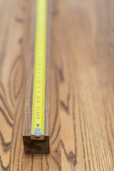 Roulette tape lying on a wooden tabletop