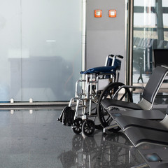 Wheelchair prepared for a passenger in the waiting room at the international airport