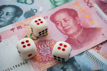 Chinese dice on Chairman Mao portrait 100, 20, 10 Chinese paper currency Yuan renminbi banknotes...