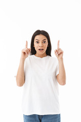 Smiling young casual woman standing isolated