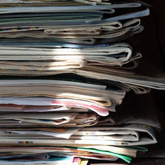 Pile of old newspapers and magazines, stack, side view.  Vintage background