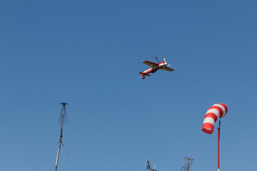 Condensation trace highlighted by the setting sun behind a plane in the blue sky. Condensation track the outdated inversion trail
