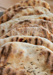 Freshly baked flatbread on baking paper.