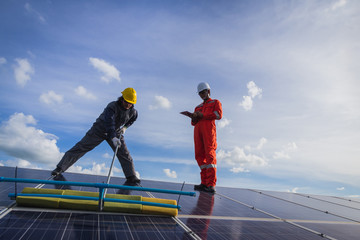 operation and maintenance in solar power plant ; engineering team working on checking and maintenance in solar power plant ,solar power plant to innovation of green energy for life