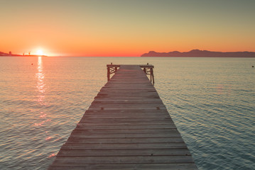 Obraz na płótnie Canvas Morning by the beach. Playa de Muro, sunrise sky in background
