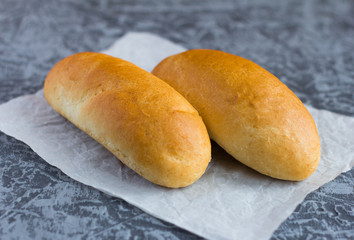 fresh crusty rolls for Breakfast on a grey background