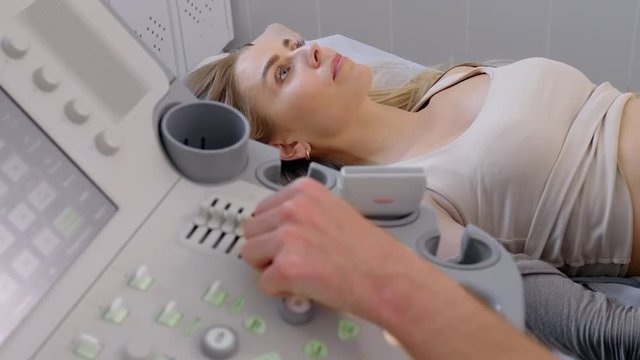 Doctor makes an ultrasound examination of a woman