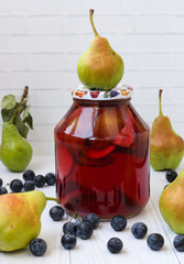 Compote of pears with blackthorn in a jar on a white background, Harvest for the winter